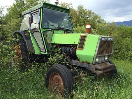 A wrecked Deutz-Fahr tractor overgrown in a bush