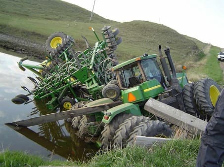 A John Deere tractor fallen into a pond